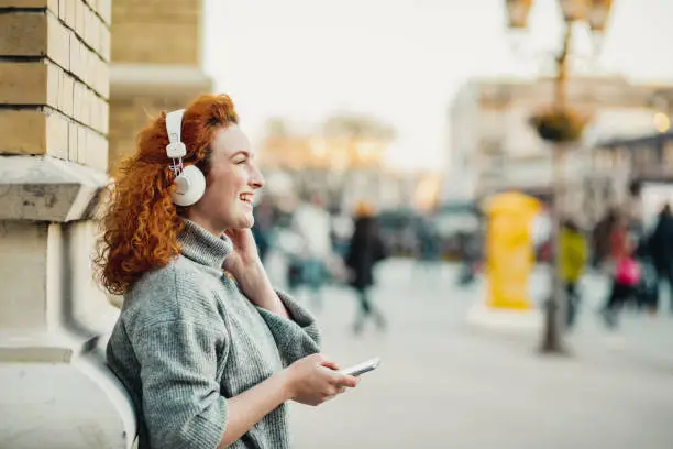 Portrait of a casual young woman listening music