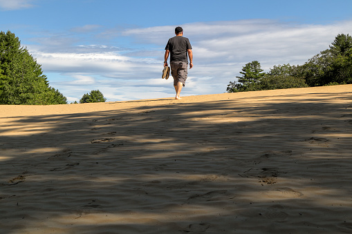A man hiking in the beautiful Desert of Maine park near Freeport, Maine