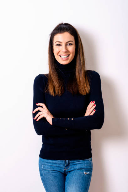 istock Beautiful woman wearing turtleneck sweater while standing at isolated white background 1207104171