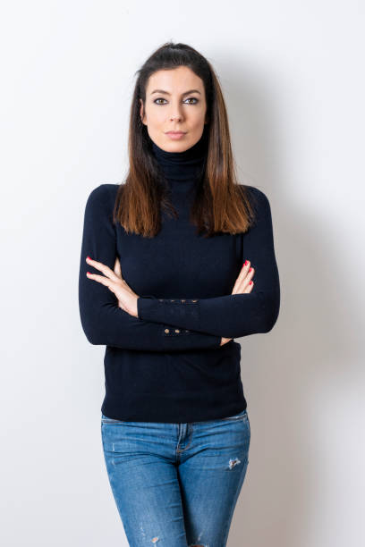 istock Beautiful woman wearing turtleneck sweater while standing at isolated white background 1207104194