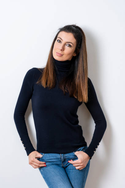 istock Beautiful woman wearing turtleneck sweater while standing at isolated white background 1207104198
