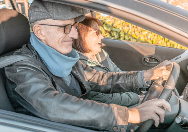 istock Retired couple enjoying time traveling - middle-aged couple having fun together using smartphone - happy mature people enjoying technology - warm contrast filter 1207105598