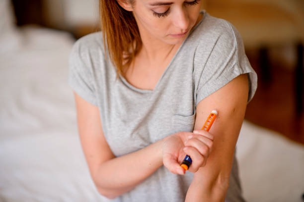 istock Young woman injecting insulin in her arm 1207105679