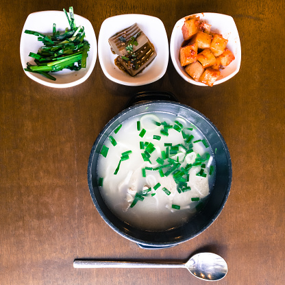 Seolleongtang (Ox Bone Soup), milky beef bone soup and several side dishes. It is a local dish of Seoul, South Korea. Top view