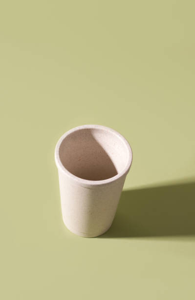 istock Reusable cup made of straw empty on a green background. 1207106728