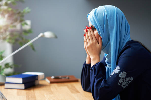 istock Unhappy muslim female student learning at home 1207107890