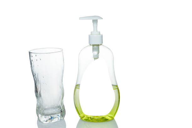 istock A bottle of detergent with a wet glass on a white background. 1207108651