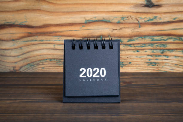 istock 2020. Black paper calendar on a wooden table 1207109791