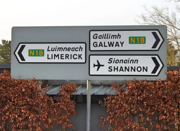 Road signs for Limerick, Shannon Airport and Galway, in English and translated into Irish, at Bunratty, County Clare, Ireland.
