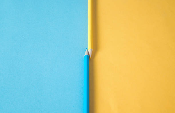 istock blue and yellow pencils and papers 1207112455