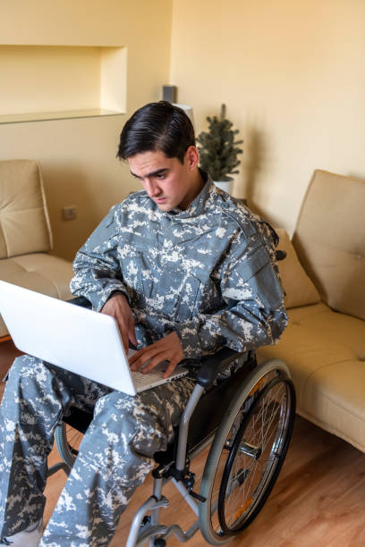 istock War Veteran With Physical Disabilities is Using a Laptop to Communicate with his Family 1207112553
