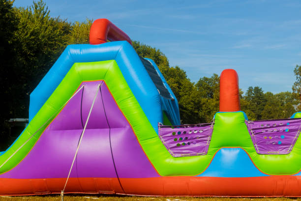 istock Funny in an inflatable castle slides colorful in playground 1207112700