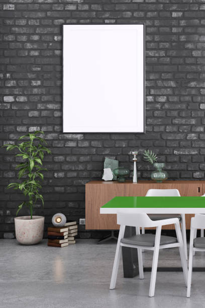 istock Office space with blank white poster frame and black wall. 1207114130