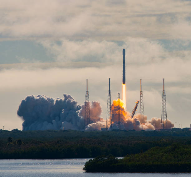 rocket launch 2-17 2 Launch of SpaceX Falcon 9 rocket with fifth Starlink mission. This is the fourth flight of the previously flown booster. The booster is powered by 9 Merlin engines. The payload deployment was successful but the landing of the returning booster failed. The rocket is about to clear the lightning arrestor towers and a bright orange plume of smoke is visible below the rocket.
February 17, 2010
Cape Canaveral, Florida, USA robertmichaud stock pictures, royalty-free photos & images
