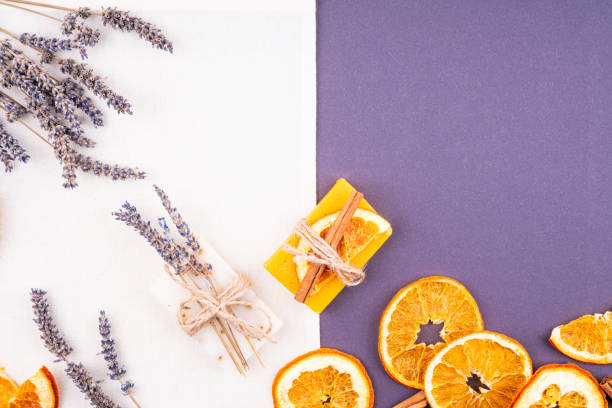 istock Two pieces of soap, lavender and oranges. 1207115310