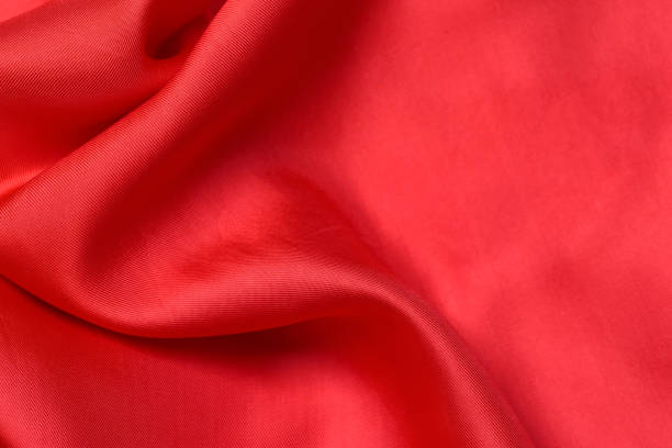 istock fabric texture. abstract background with soft waves. Smooth elegant red silk or satin luxury cloth 1207115569