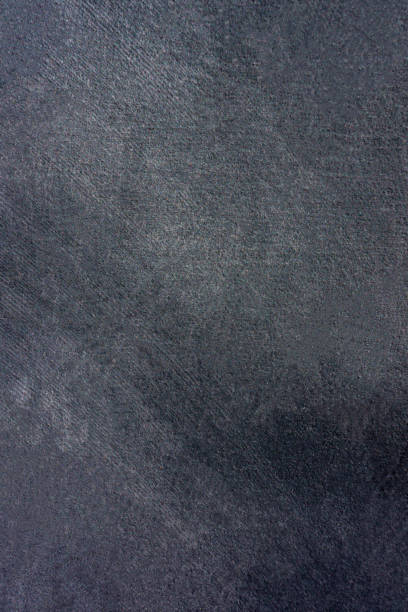 istock dark surface of stucco wall with traces of processing. 1207115593