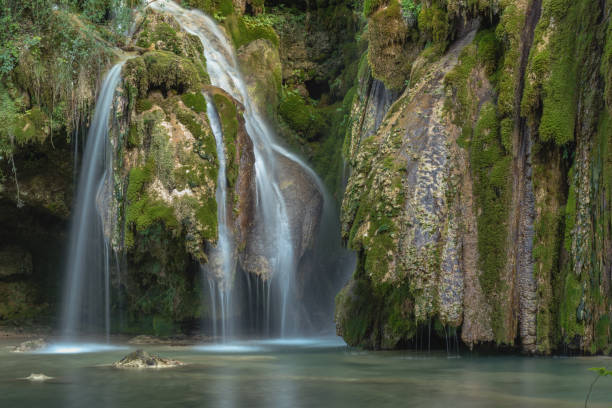 Waterfall of tuffs in the jura Waterfall of tuffs with boards near Arbois jura stock pictures, royalty-free photos & images