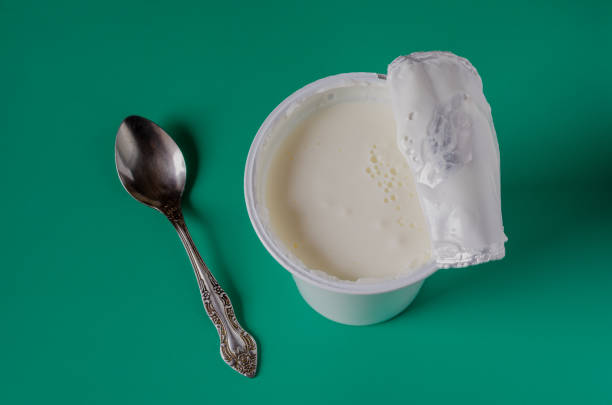 istock Tasty yogurt in a white plastic glass. 1207117225