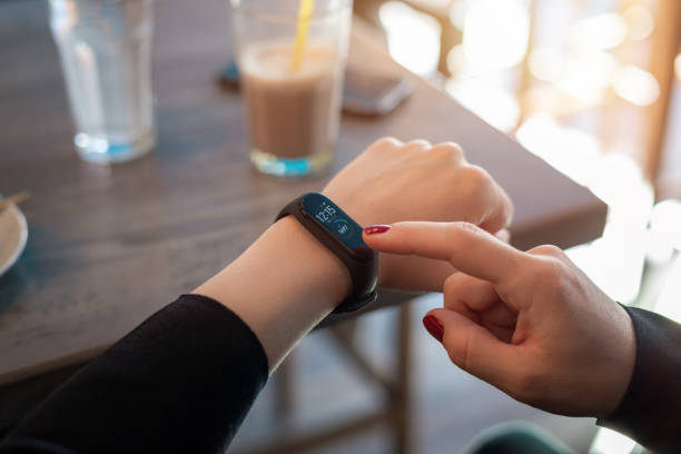 istock Girl uses apss on her smart band to view health parameters 1207120239
