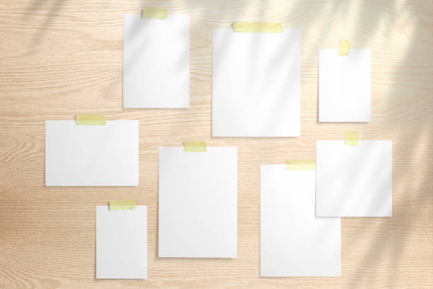 istock Moodboard template composition with blank photo cards,  polaroid frame glued with yellow adhesive tape on wooden desk with floral shadow overlay. 1207120856