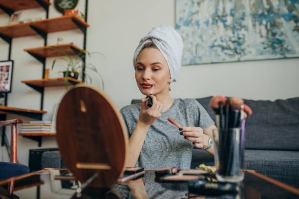 istock Young woman in her apartment doing her make up 1207121793