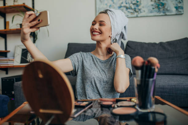 istock Young woman in her apartment creating a make up selfie 1207122243