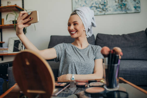 istock Young woman in her apartment creating a make up selfie 1207122387