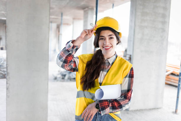 istock Construction engineer girl with drawings at hand 1207122417