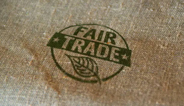Fair Trade stamp printed on linen sack. Ethical business, green trade, sustainable economy and environmental care concept.