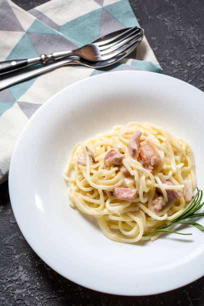 istock Pasta carbonara served on deep plate decorated with rosemary. 1207126177