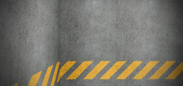 istock Yellow striped line painted on concrete wall 1207127043