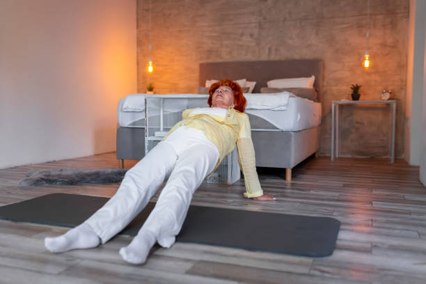 istock Senior woman exercising at home 1207130623