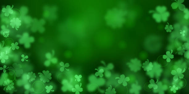 Background on St. Patrick's Day Background on St. Patrick's Day made of blurry clover leaves in green colors lucky stock illustrations