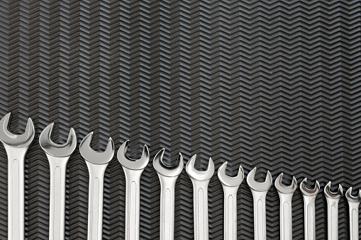 Car repair tools, wrench tool set on a black texture background