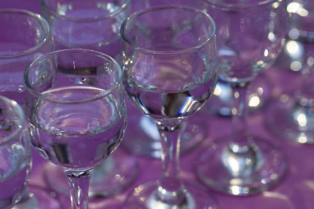 istock Elegant water glasses served on violet table, close up, top view 1207131310