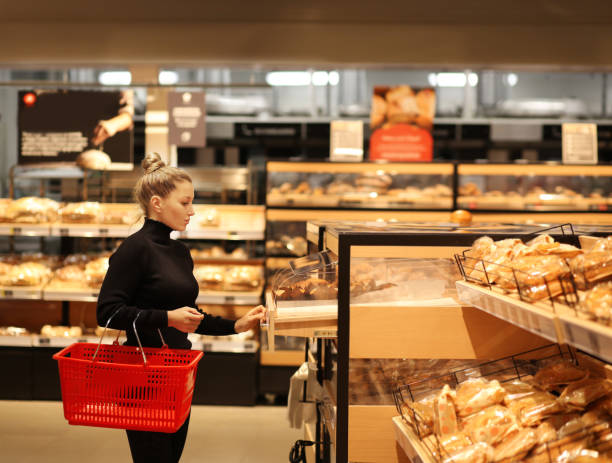 istock Woman choosing bread  from a supermarket 1207136733
