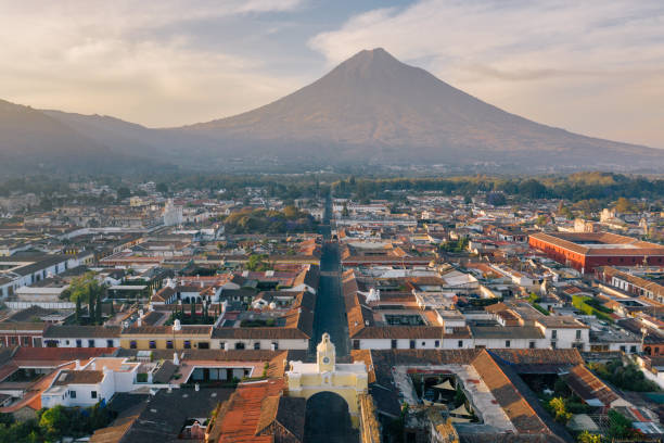 Sunrise above Antigua (Guatemala) Areal photo of the historic old town of Antigua in Guatemala, surrounded by their active volcanos. guatemala stock pictures, royalty-free photos & images