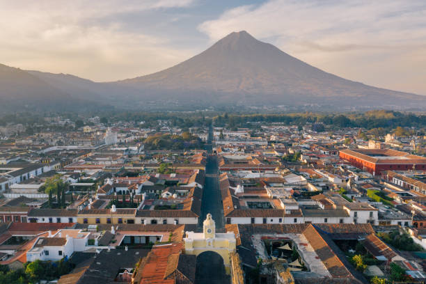 Sunrise above Antigua (Guatemala) Areal photo of the historic old town of Antigua in Guatemala, surrounded by their active volcanos. guatemala landscape stock pictures, royalty-free photos & images