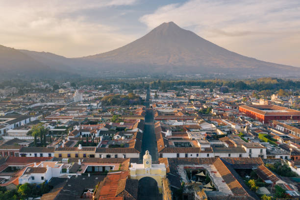 Sunrise above Antigua (Guatemala) Areal photo of the historic old town of Antigua in Guatemala, surrounded by their active volcanos. Central America stock pictures, royalty-free photos & images