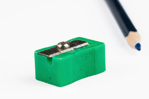 istock Old green pencil sharpener and pencil isolated on white background.Copy space. 1207144014