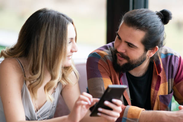 istock Man and woman looking at the phone screen 1207149933