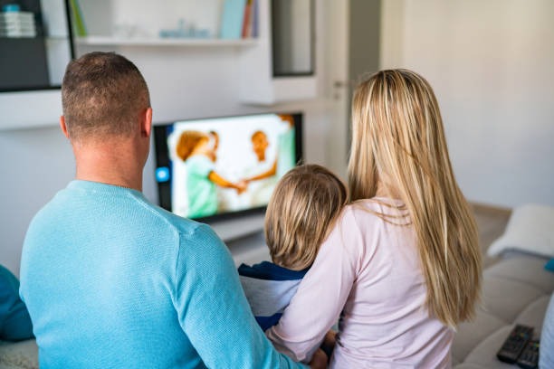 istock Family watching TV 1207151459