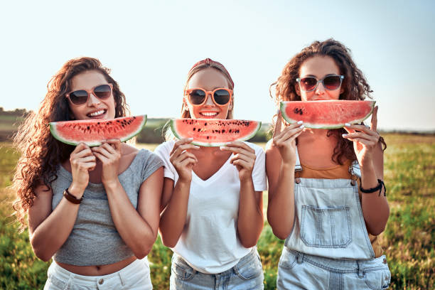 Three Nice Girls Having Fun Eating Watermelon In The Park Stock Photo - Download Image Now - iStock Three Nice Girls Having Fun Eating Watermelon In The Park Stock Photo - Download Image Now - iStock