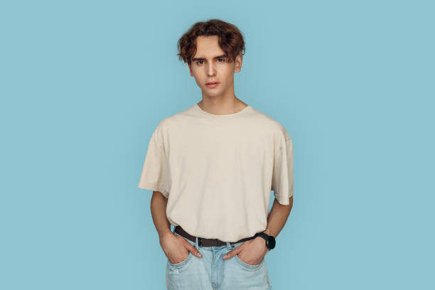 istock Freestyle. Man standing isolated on gray hands in pockets posing pensive 1207153271