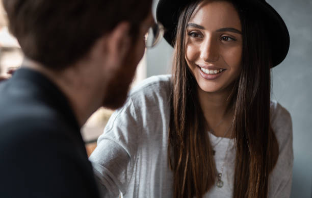 istock Delighted lady communicating with boyfriend in restaurant 1207153469