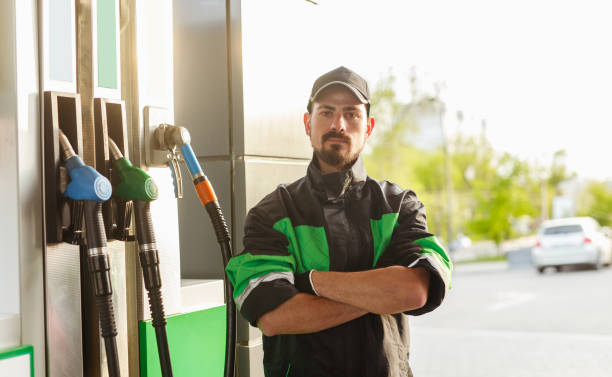 istock Confident employee near gas pump 1207153508