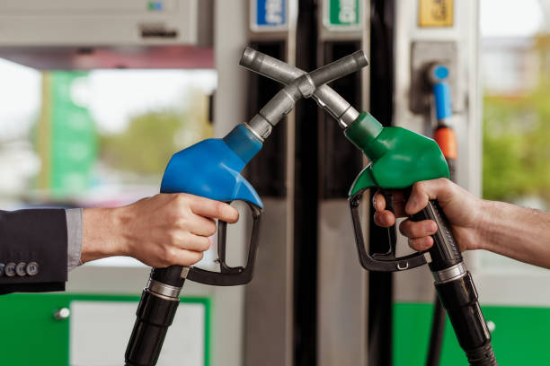 istock Crop hands crossing gas and diesel nozzles 1207153513