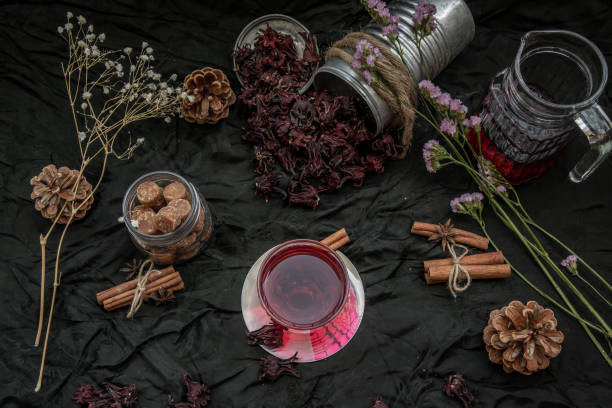 istock Roselle tea (Jamaica sorrel, Rozelle or hibiscus sabdariffa ) with dry roselle and brown cane sugar cube. 1207153996