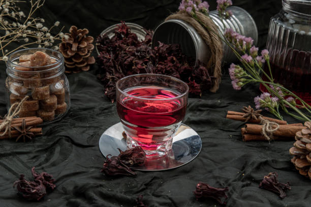 istock Roselle tea (Jamaica sorrel, Rozelle or hibiscus sabdariffa ) with dry roselle and brown cane sugar cube. 1207154014